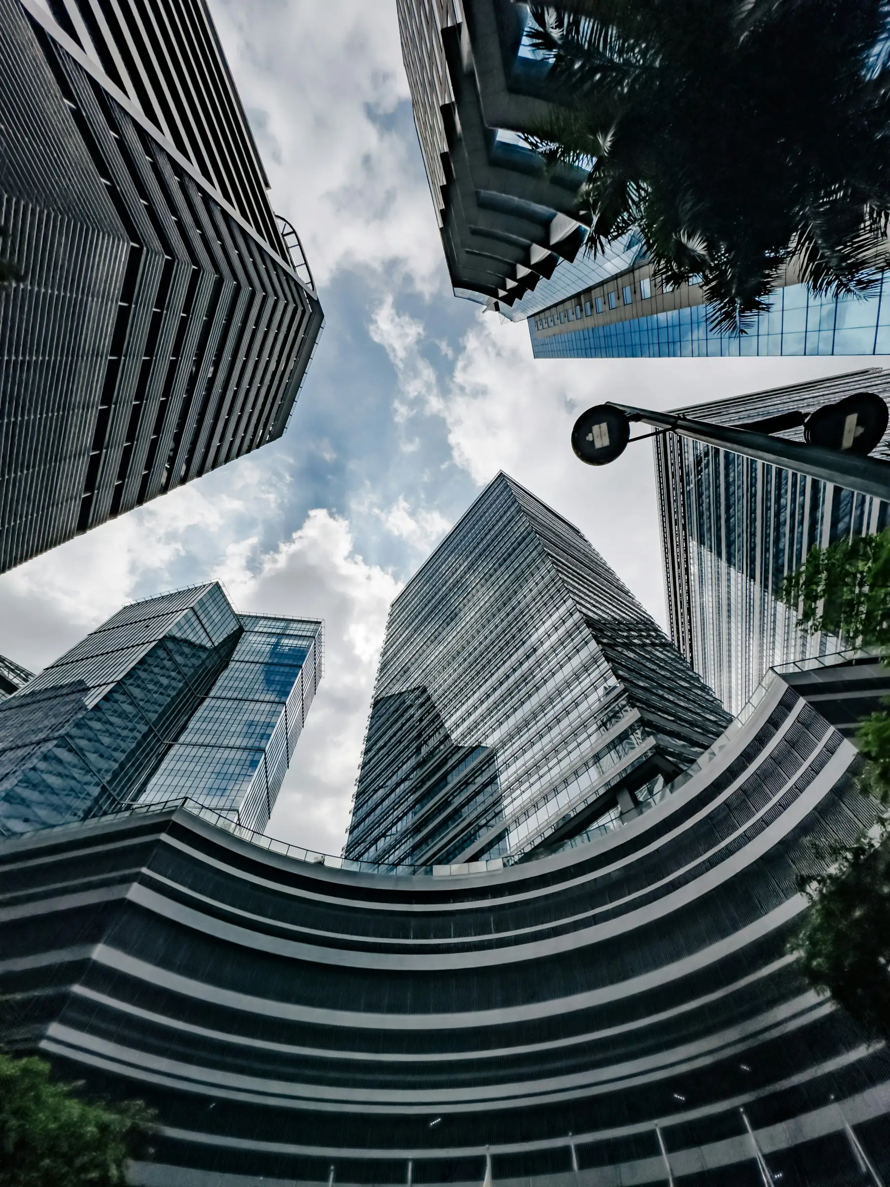 Upward view between modern office towers in a Philippine business district.